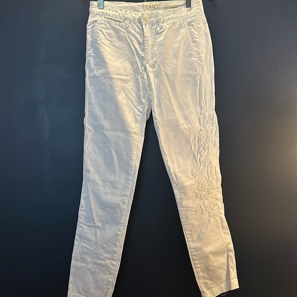 Anthropologie white straight pants with cream embroidered flowers. Size 27